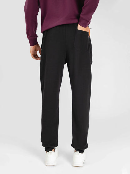 Black jogger pants with drawstring waist and tapered leg openings.