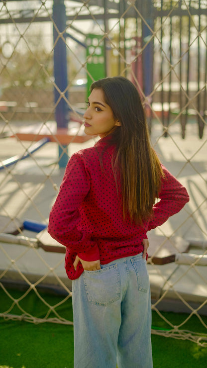Red polka-dot hoodie with bow tie, long sleeves, paired with light blue jeans