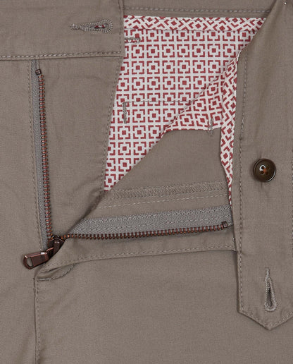Light grey trousers with red geometric lining, button closure, and zip fly