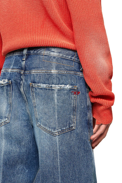 Blue wash denim jeans detail, rear pocket with logo patch and stitching