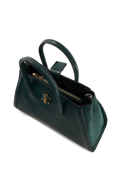 Dune London green handbag angled view with bee charm, zip top, and strap