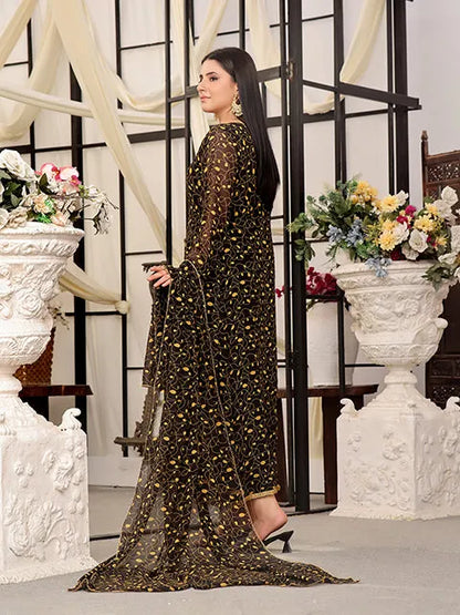 Nazmina maxi dress in dark with gold swirl pattern, side view and flared skirt