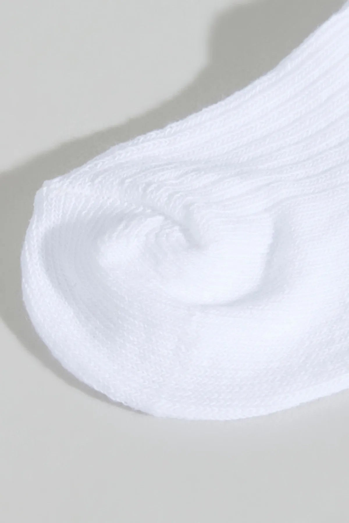 Close-up of white ribbed baby crew sock