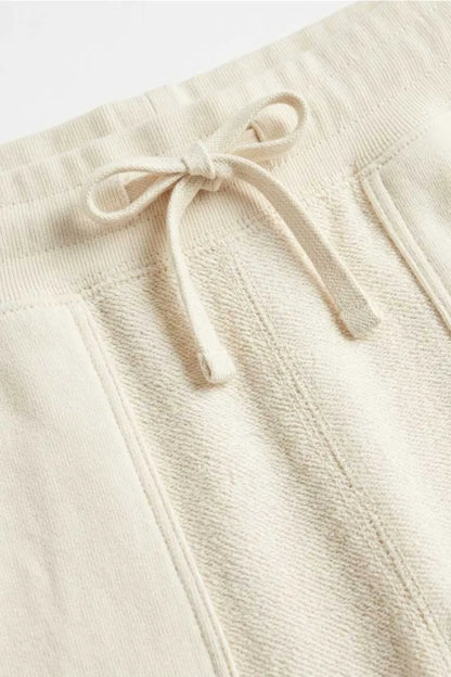 MEME cream jogger pants drawstring close-up with matching cord