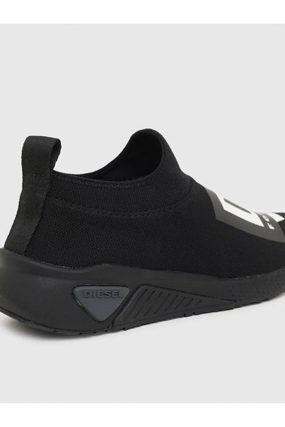 Black Diesel slip-on sneaker close-up, rear logo patch and grippy sole detail