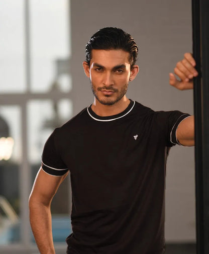 Men's fitted black t-shirt with white-trim collar, sleeve edges, small chest logo