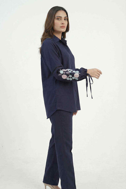 Navy blue tunic shirt and matching pants set, side view with floral embroidered cuffs