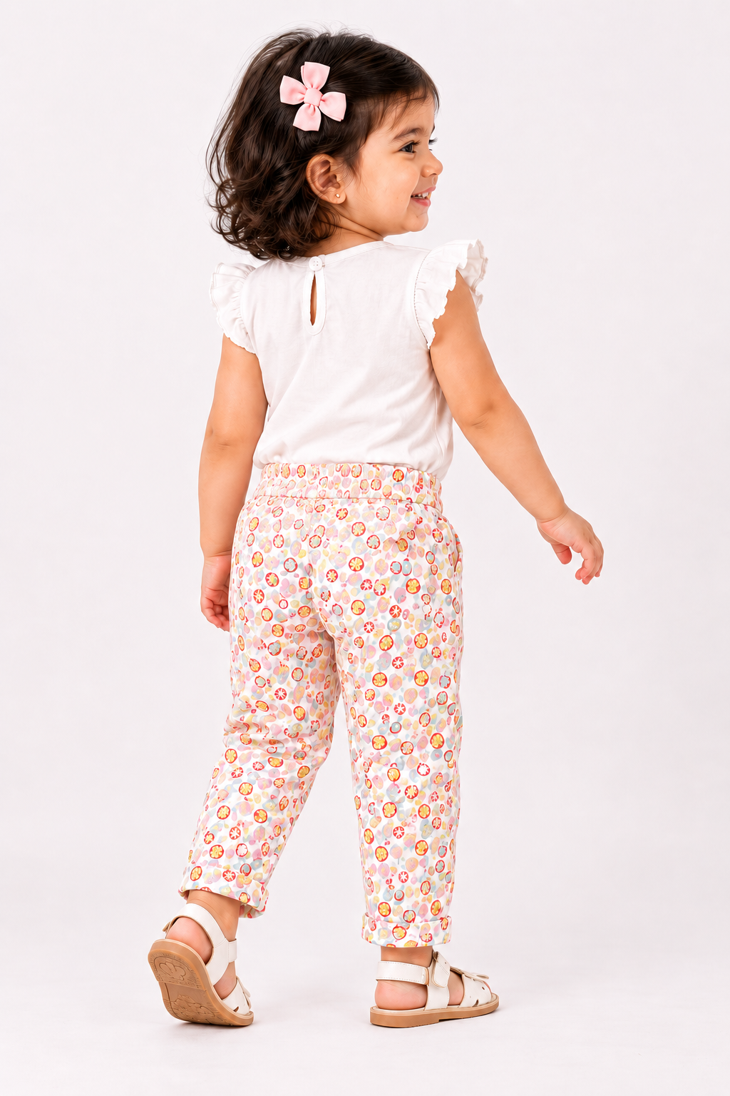 BABYSHOP baby pants, white with colorful fruit print, ankle-length, side view