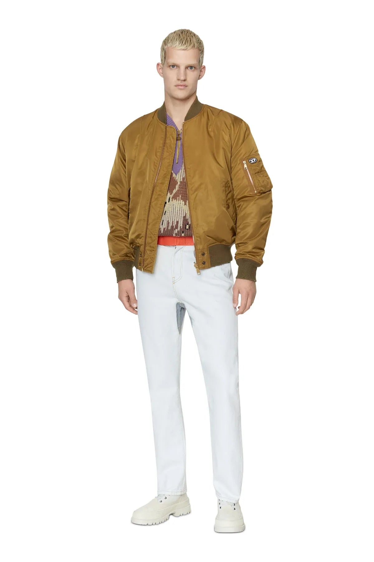 Tan bomber jacket worn over a graphic T-shirt with ribbed knit hem