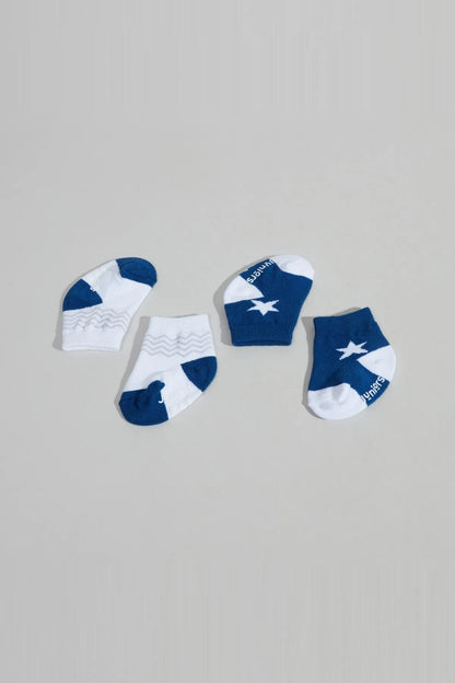 Baby sock set of four: two white with blue plane print and two dark blue socks.