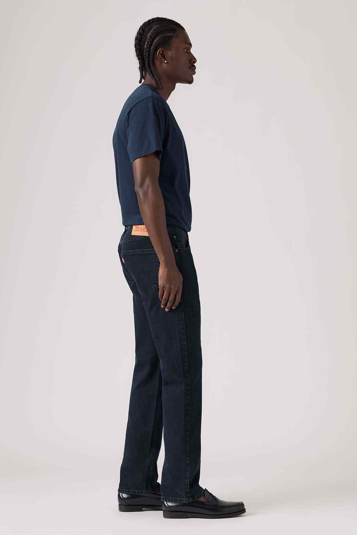 Dark blue denim jeans, side view with straight leg and visible belt loops