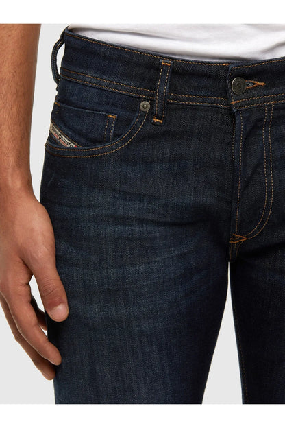 Blue denim jeans pocket with orange stitching and rivet details on the front.