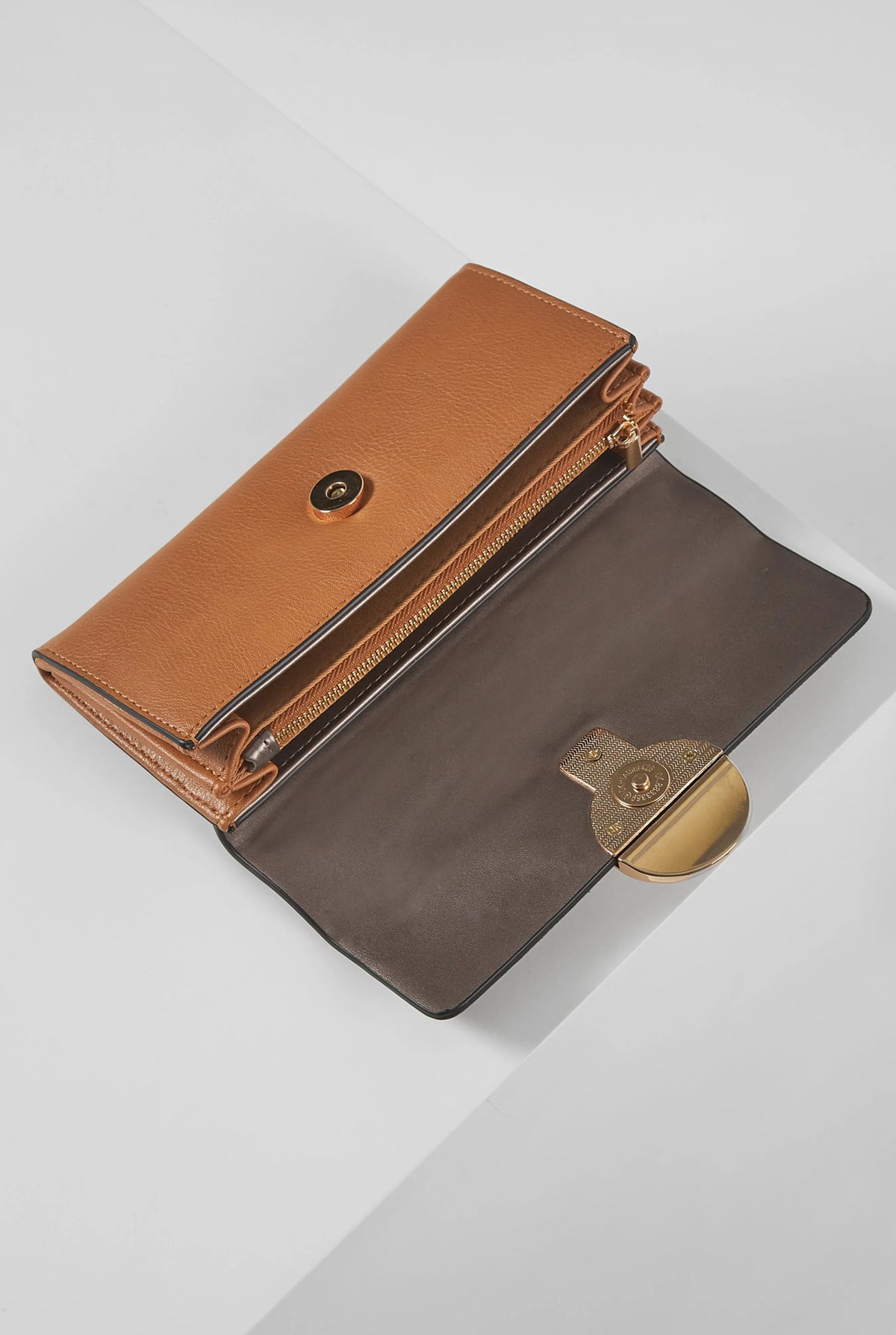 Two-tone brown leather wallet with zip pocket and snap strap