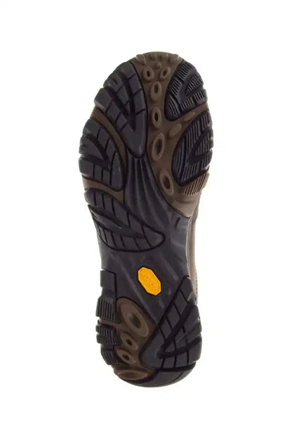 Bottom view of dark earth rubber outsole with deep traction lugs and yellow emblem
