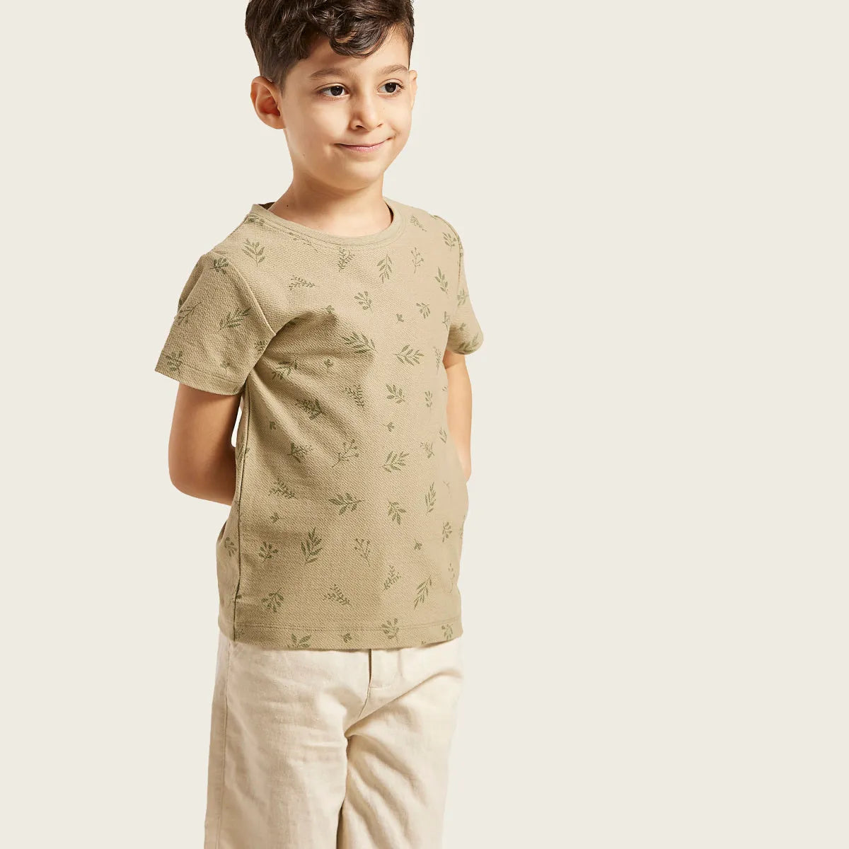 Kids short-sleeve T-shirt in tan with subtle green leaf pattern