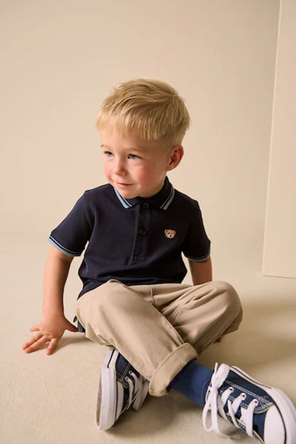 Navy kids polo shirt with button placket and striped inner collar trim