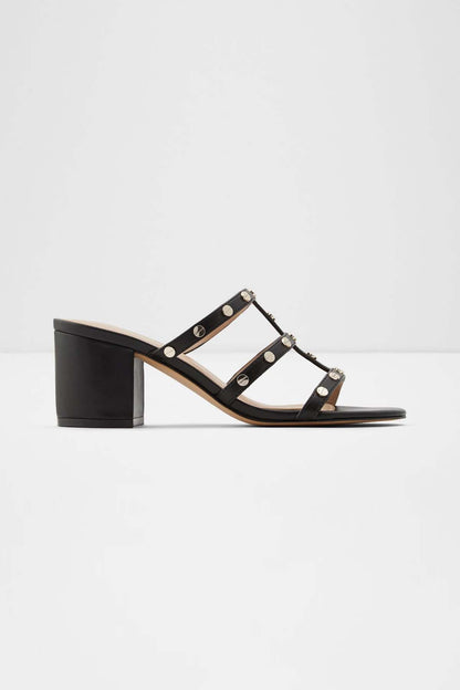Black studded heeled sandals with open toe and round metal rivets, block heel