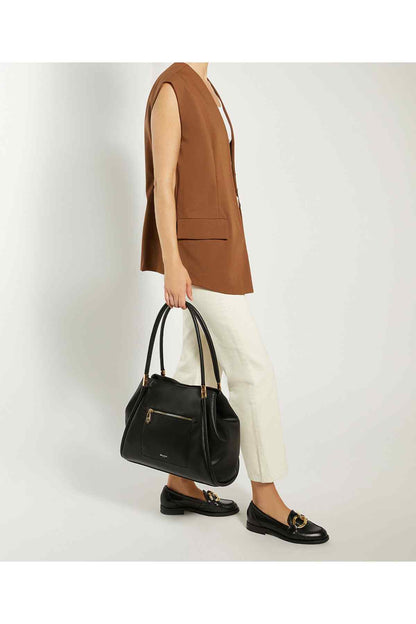 Dune London black mini handbag with adjustable shoulder strap, side view