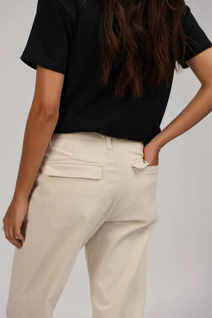 Ecru cropped trousers close-up with belt loops and patch pockets