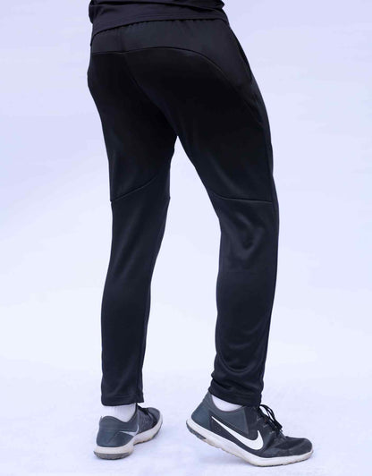 Black jogger pants with smooth knee and angled seam, back view