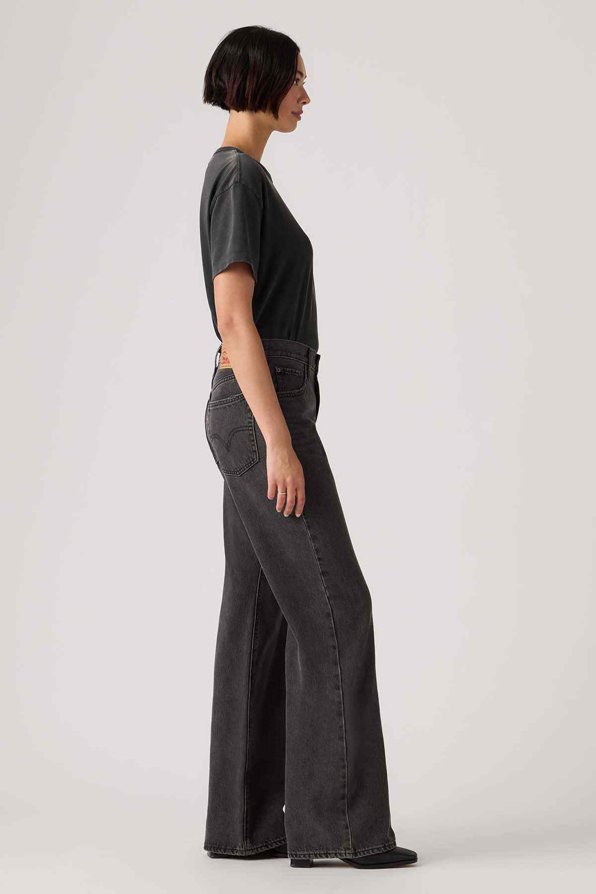 Black wide-leg denim jeans shown from the side, with belt loops