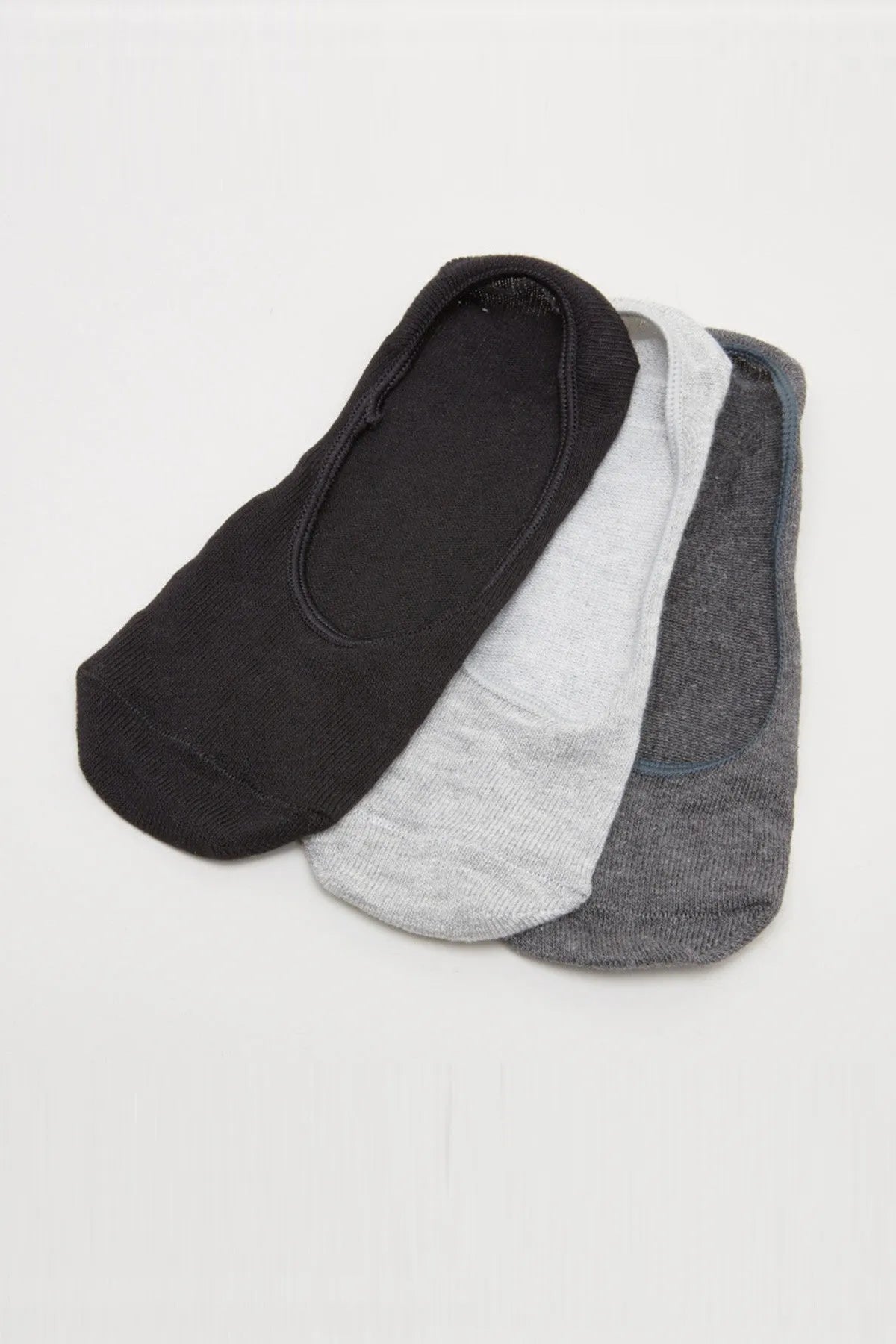 Stacked baby no-show socks in black, light gray, and dark gray