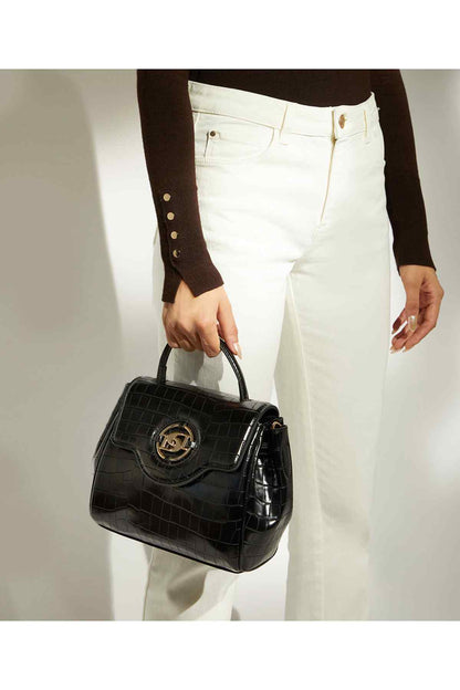 Black croc-embossed handbag worn with white jeans, top handle and shoulder strap