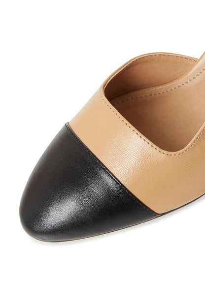 Two-tone slingback shoe close-up, black rounded toe cap with camel upper panels