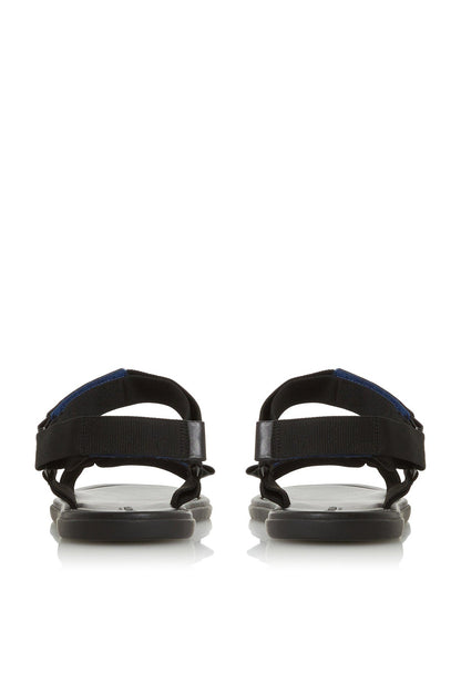 Black flat sandals with wide back straps and blue stitching detail