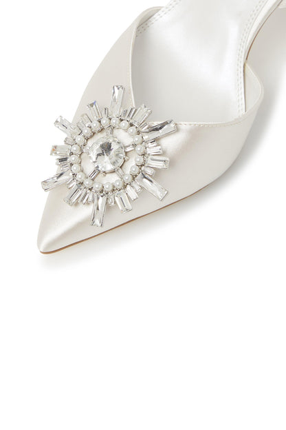 Ivory pointed-toe heeled sandal with crystal starburst brooch on upper