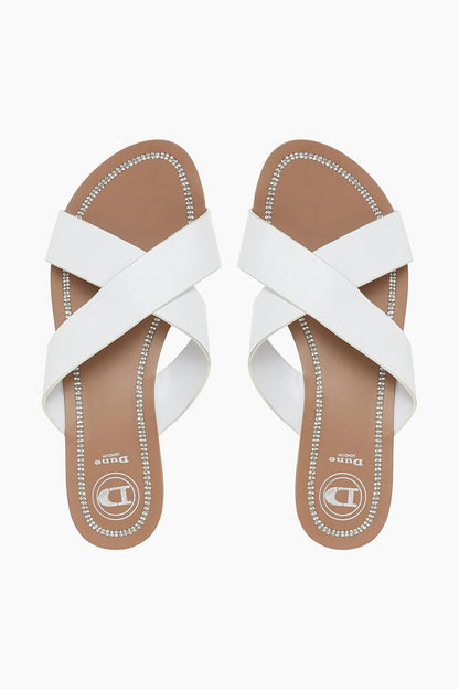 Dune London white two-strap sandals with rhinestone trim and brown footbed.