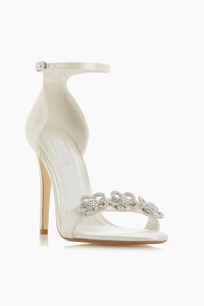 Ivory open-toe heeled sandal with ankle strap and rhinestone bow embellishment