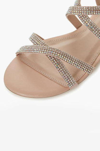 Blush rhinestone toe-strap sandals with jeweled bands across foot