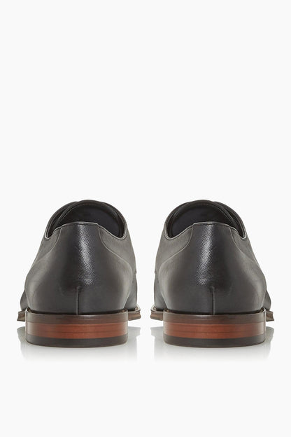 Black leather lace-up oxford shoes with brown sole, heel back view