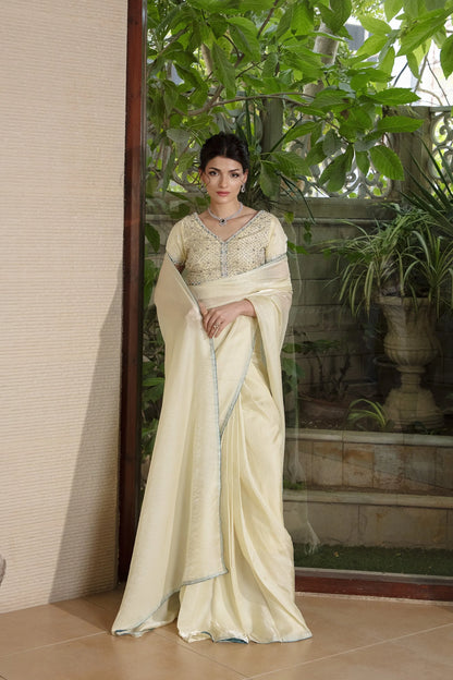 Cream velour saree with beaded V-neck blouse and light-blue trim, full length