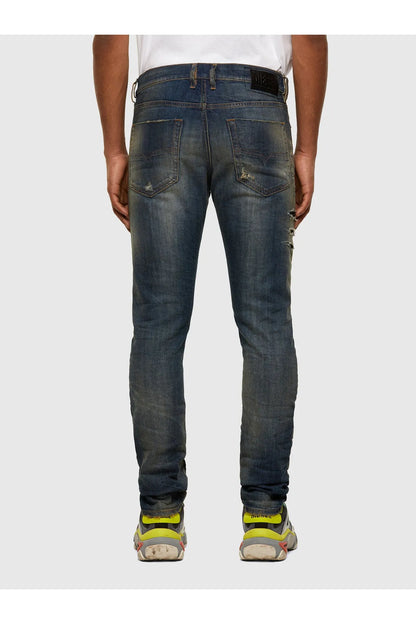 Blue jeans with belt loops, button fly, and small distressed patches