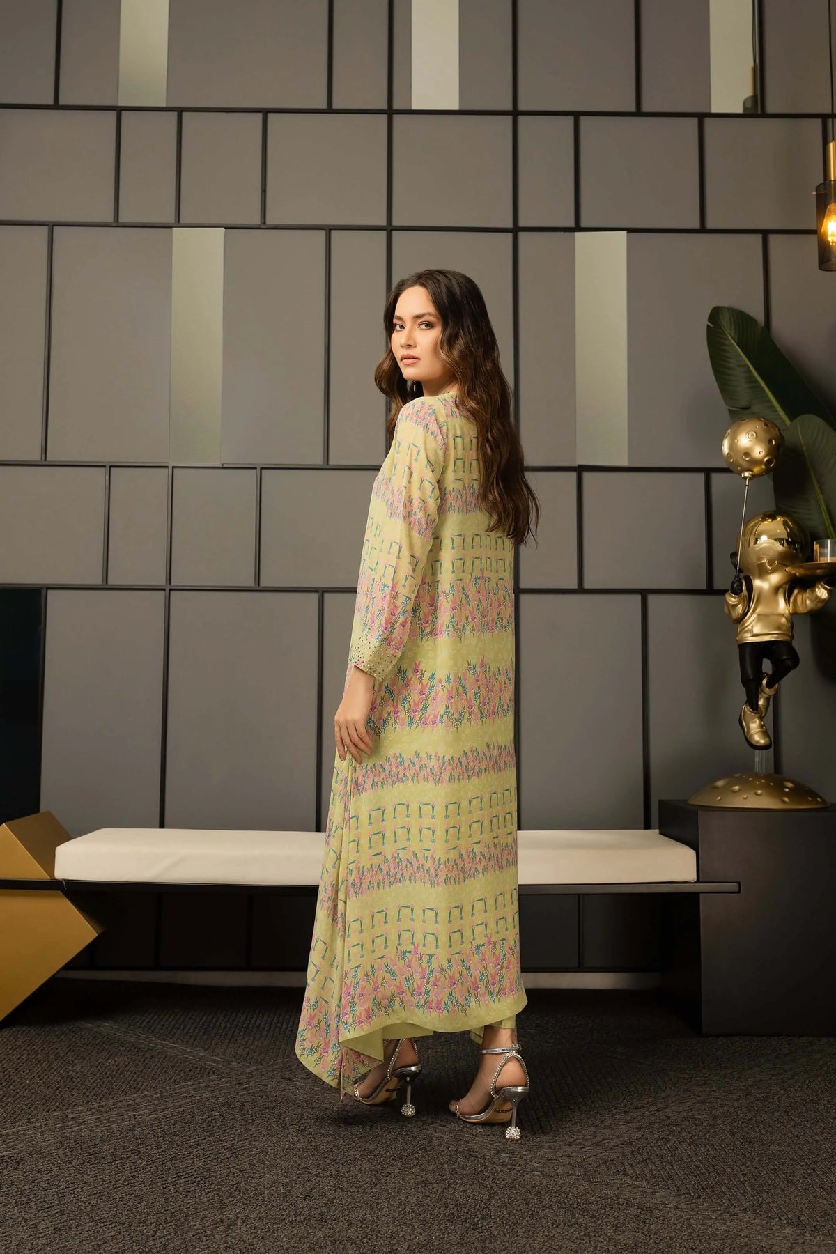 Pistachio printed maxi dress in side view with flowing, tiered hem
