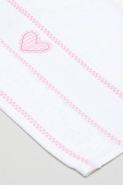 Baby blanket corner detail with pink heart applique and stitched stripes