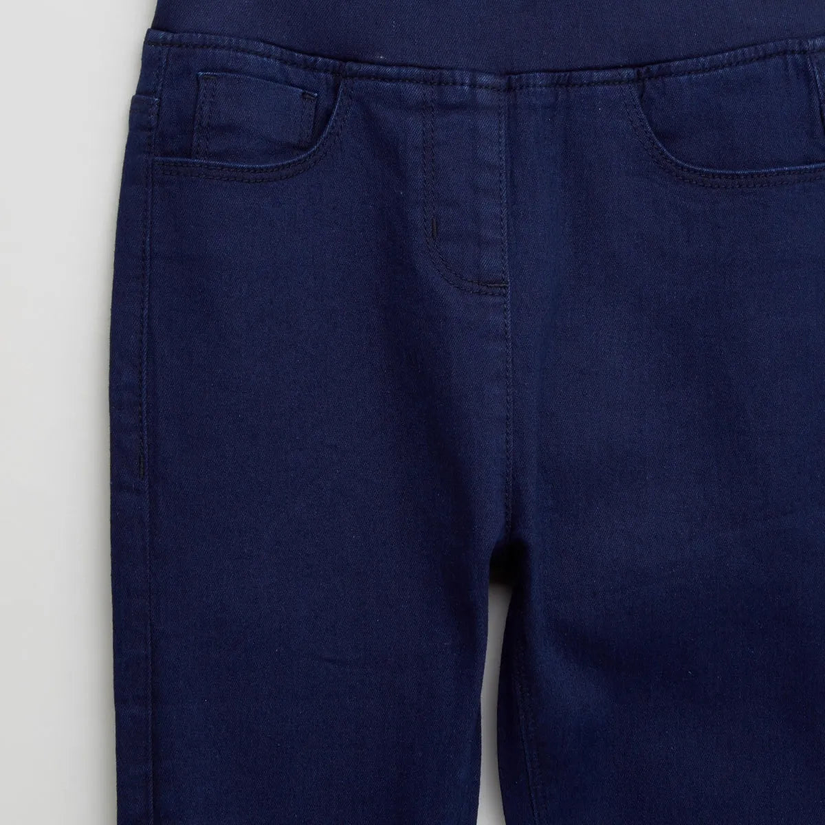 Baby jeans front view: dark blue denim with front pockets and waistband stitching