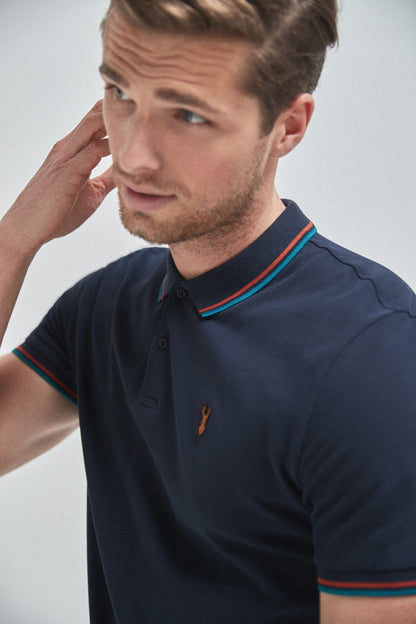 Navy short-sleeve polo shirt with button placket, collar trim, and small chest logo