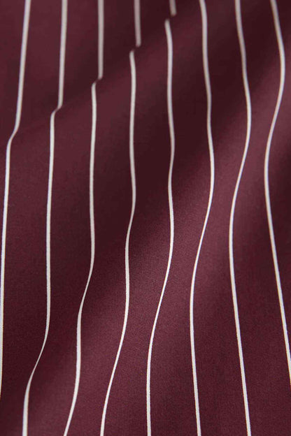 Wine pinstripe shirt fabric close-up with white vertical stripe pattern
