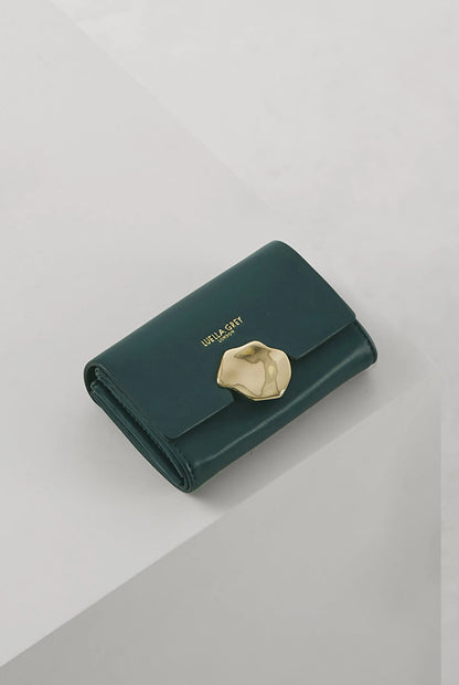 Green leather flap wallet with gold snap button closure