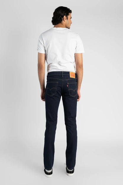 Levi's dark indigo denim jeans, back view with leather patch and straight legs