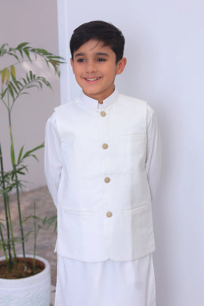 Boys white vest-style top with band collar and gold button front, close-up