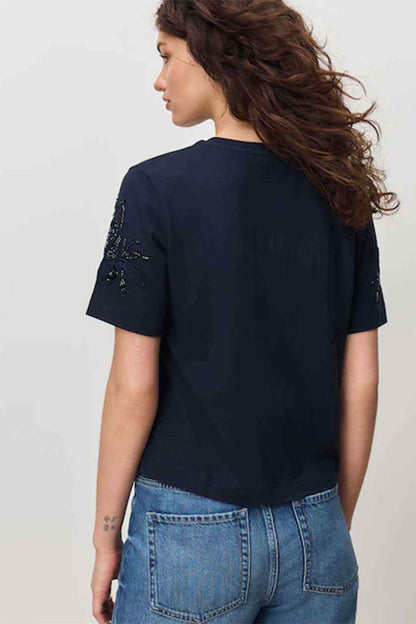 Navy short-sleeve top, back view, with embroidered shoulders and sleeves