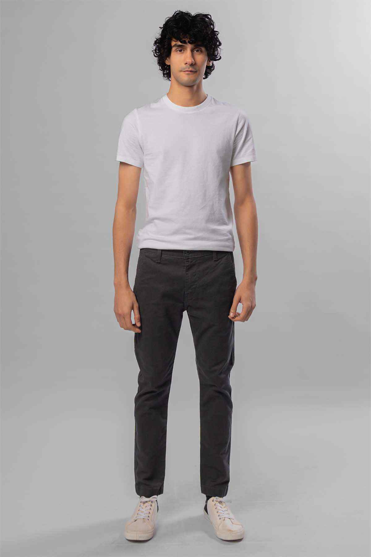 Men's dark grey jeans front view, worn with a white short-sleeve T-shirt