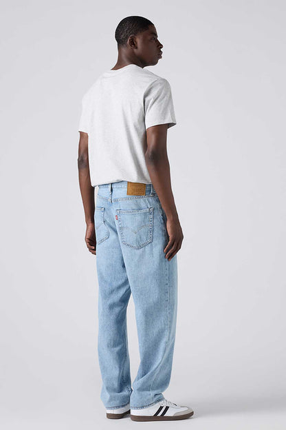 Levi's light-wash denim jeans, side view, relaxed straight fit with belt loops