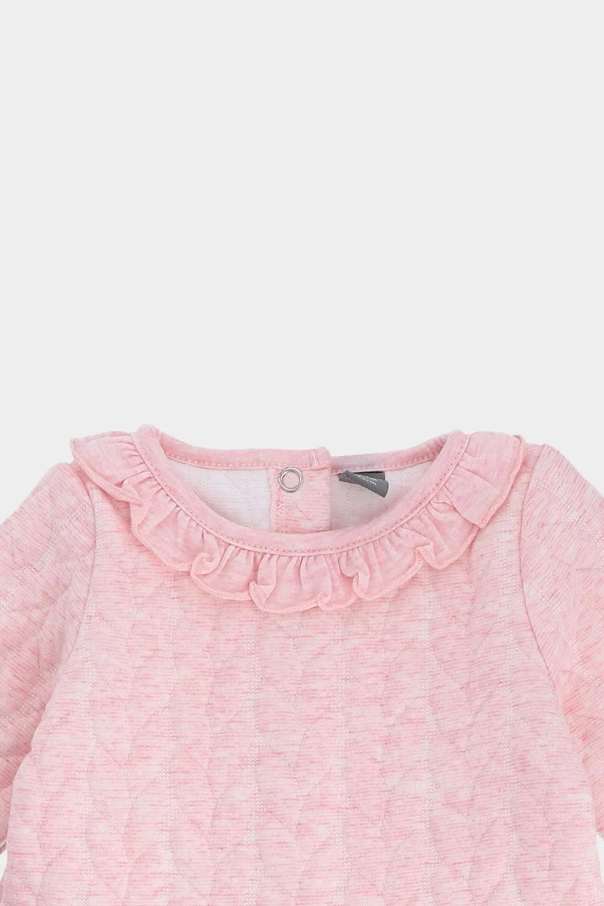 Pink baby dress neckline with ruffled trim and snap button placket
