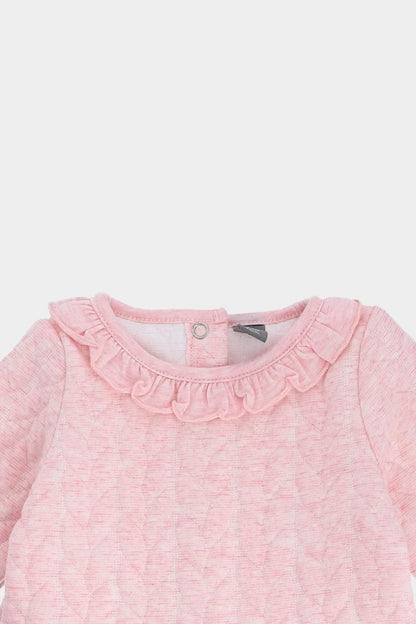 Pink baby dress neckline with ruffled trim and snap button placket