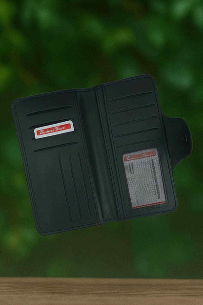 Dark leather bifold wallet open with card slots and ID window